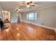 Bright living room featuring hardwood floors, a fireplace, and a large window that fills the space with natural light at 511 W Main St, Cleveland, NC 27013