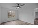 Bright bedroom with hardwood flooring, ceiling fan, closet, and large window at 5680 Gold Creek Bay None, Hickory, NC 28601