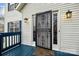 This home's front door is painted white and accented with blue trim, and it has a security gate at 5680 Gold Creek Bay None, Hickory, NC 28601