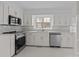 Bright white kitchen with stainless steel appliances and matching white cabinetry at 5680 Gold Creek Bay None, Hickory, NC 28601