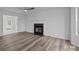 Open concept living room with hardwood floors and fireplace focal point at 5680 Gold Creek Bay None, Hickory, NC 28601