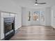 Bright living room features a fireplace, bay window, and modern ceiling fan at 5680 Gold Creek Bay None, Hickory, NC 28601