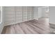 Living room with built-in shelves, laminate wood flooring, and natural light at 5680 Gold Creek Bay None, Hickory, NC 28601