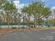 Basketball hoop next to the tennis court, offers community space for athletic activities and outdoor recreation at 6225 Woodleigh Oaks Dr, Charlotte, NC 28226