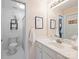 Charming bathroom features a white vanity, framed mirror, and decorative wall art at 6225 Woodleigh Oaks Dr, Charlotte, NC 28226