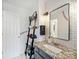 Stylish bathroom featuring a granite countertop, black accents, and a framed mirror at 6225 Woodleigh Oaks Dr, Charlotte, NC 28226