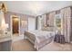 Charming bedroom with a chandelier, plush carpet, and plenty of natural light at 6225 Woodleigh Oaks Dr, Charlotte, NC 28226