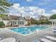 Large community pool with lounge chairs and a clubhouse under a sunny sky, perfect for relaxation at 6225 Woodleigh Oaks Dr, Charlotte, NC 28226