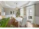 Bright dining room with modern lighting fixture, large windows, and beautiful hardwood floors at 6225 Woodleigh Oaks Dr, Charlotte, NC 28226