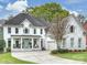 Stunning white brick home featuring a well-manicured lawn and attached two-car garage at 6225 Woodleigh Oaks Dr, Charlotte, NC 28226