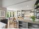 Open kitchen with white cabinetry, granite counters, and a breakfast bar overlooking the dining area at 6225 Woodleigh Oaks Dr, Charlotte, NC 28226
