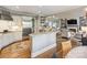 Open-concept kitchen with granite countertops, stainless steel appliances, and breakfast bar overlooking the living area at 6225 Woodleigh Oaks Dr, Charlotte, NC 28226