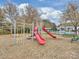 Community playground featuring colorful slides, swings, and climbing structures for enjoyment at 6225 Woodleigh Oaks Dr, Charlotte, NC 28226