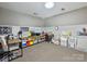 Spacious playroom with neutral carpet and custom storage solutions, perfect for organizing toys and learning materials at 6225 Woodleigh Oaks Dr, Charlotte, NC 28226