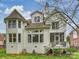Rear exterior view showcasing a white brick home with a deck, bay windows, and well-maintained landscaping at 6225 Woodleigh Oaks Dr, Charlotte, NC 28226