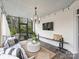 Spacious screened porch with white brick accent wall, comfortable seating, and overhead string lights at 6225 Woodleigh Oaks Dr, Charlotte, NC 28226