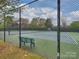 Fenced tennis court offers a community space for athletic activities and outdoor recreation at 6225 Woodleigh Oaks Dr, Charlotte, NC 28226
