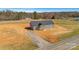 New construction home with gray siding, dark roof, and a covered front porch, nestled on a sizable lot near wooded area at 629 Mt. Wesley Church Rd, Hiddenite, NC 28636