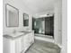 Modern bathroom featuring a double vanity, and a glass-enclosed shower with black tile at 629 Mt. Wesley Church Rd, Hiddenite, NC 28636