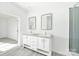 Modern bathroom with double vanity, mirrors, and a glass-enclosed shower at 629 Mt. Wesley Church Rd, Hiddenite, NC 28636