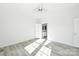 Empty bedroom featuring a ceiling fan, two windows, white walls, and gray flooring at 629 Mt. Wesley Church Rd, Hiddenite, NC 28636