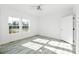 Bright bedroom with natural light from two windows and white walls and gray flooring at 629 Mt. Wesley Church Rd, Hiddenite, NC 28636