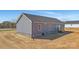 An aerial view highlights the home's rear and side views, gray siding, dark roof, back entrance and spacious lot at 629 Mt. Wesley Church Rd, Hiddenite, NC 28636