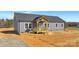 New construction home featuring gray siding, a dark gray roof, and a charming, covered front porch at 629 Mt. Wesley Church Rd, Hiddenite, NC 28636