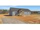 New construction home with gray siding, a dark roof, and a charming, covered, wood-framed front porch at 629 Mt. Wesley Church Rd, Hiddenite, NC 28636