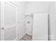 Well-lit laundry room features modern door, utility connections, practical shelf for storage, and washer/dryer space at 629 Mt. Wesley Church Rd, Hiddenite, NC 28636