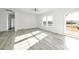 Bright living room featuring wood-look floors, recessed lighting, and natural light from two windows at 629 Mt. Wesley Church Rd, Hiddenite, NC 28636
