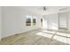 Bright living room featuring wood-look floors, recessed lighting, and natural light from two windows and open doorway at 629 Mt. Wesley Church Rd, Hiddenite, NC 28636