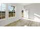 Bright living room featuring wood-look floors, recessed lighting, and natural light from two windows and open doorway at 629 Mt. Wesley Church Rd, Hiddenite, NC 28636
