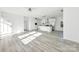 Open floor plan with kitchen island and stainless appliances, featuring wood-look floors and recessed lighting at 629 Mt. Wesley Church Rd, Hiddenite, NC 28636