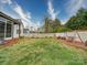 Spacious backyard featuring a white picket fence, swing set, and lush green lawn at 630 Deese Rd, Monroe, NC 28110