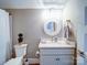 Cozy bathroom features a vanity with granite top and a round mirror, creating a functional and stylish space at 630 Deese Rd, Monroe, NC 28110