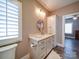 Well-lit bathroom vanity with round mirror, ample storage, and stylish fixtures at 630 Deese Rd, Monroe, NC 28110
