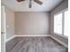 Neutral bedroom showcases modern flooring and a bright window with white shutters at 630 Deese Rd, Monroe, NC 28110