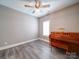 Cozy bedroom featuring a wood-blade ceiling fan and elegant, dark wood Yamaha piano at 630 Deese Rd, Monroe, NC 28110