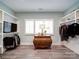Walk-in closet with ample shelving, a dresser, and three windows, creating an organized and bright dressing area at 630 Deese Rd, Monroe, NC 28110