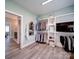 Spacious closet featuring custom built-in shelving and wooden floors, providing ample storage space at 630 Deese Rd, Monroe, NC 28110
