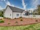 Home exterior featuring a fenced yard, well-maintained landscaping, and covered patio at 630 Deese Rd, Monroe, NC 28110