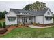 Charming home exterior with covered porch, green lawn, and landscaped garden at 630 Deese Rd, Monroe, NC 28110