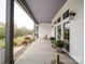Covered front porch with seating, stylish lighting, and a view of the landscaped front yard at 630 Deese Rd, Monroe, NC 28110