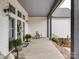 Inviting front porch with seating, potted plants, and stylish lighting fixtures at 630 Deese Rd, Monroe, NC 28110
