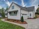 Home exterior featuring a two-car garage, well-maintained lawn, and tasteful landscaping at 630 Deese Rd, Monroe, NC 28110