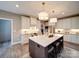 Modern kitchen with island, pendant lighting, stainless steel appliances, and white cabinetry at 630 Deese Rd, Monroe, NC 28110