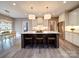Well-lit kitchen island with barstool seating, a sink, and a view of the dining area at 630 Deese Rd, Monroe, NC 28110