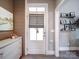 Well-organized mud room with a white cabinet and shelves for displaying photos at 630 Deese Rd, Monroe, NC 28110