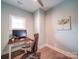 Well-lit home office with a modern desk, comfortable chair, and neutral decor for a productive workspace at 630 Deese Rd, Monroe, NC 28110